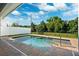 In-ground pool and spa with brick pavers, black fencing and white privacy fence at 34 Concord Dr, Dunedin, FL 34698