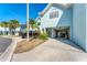 View of townhouse exterior, garage, and parking at 514 Garland Cir, Indian Rocks Beach, FL 33785