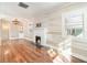 Living room with whitewashed walls, hardwood floors, and a fireplace at 6 Parkview St, Bradenton, FL 34208