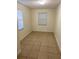 Bright bedroom with tile floors and a double-door closet at 8305 N Brooks St, Tampa, FL 33604