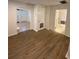 Living area with wood-look floors and views into other rooms at 8305 N Brooks St, Tampa, FL 33604