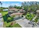 House with a waterfront view and lush green surroundings at 9045 Baywood Park Dr, Seminole, FL 33777