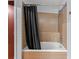 Bathroom with a tub and shower, tile surround, and black shower curtain at 912 Channelside Dr # 2320, Tampa, FL 33602