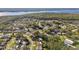 Aerial view of neighborhood with houses, roads, and a large body of water in the background at 918 Windward Way, Palm Harbor, FL 34685