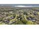 Aerial view of community, showing houses surrounded by trees and a lake in the distance at 918 Windward Way, Palm Harbor, FL 34685