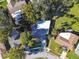 High-angle view showcasing the home's neighborhood setting and landscaping at 918 Windward Way, Palm Harbor, FL 34685