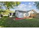 Backyard with spacious lawn, screened patio and red mulch landscaping at 918 Windward Way, Palm Harbor, FL 34685