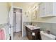 Updated bathroom with built-in storage and a linen closet at 918 Windward Way, Palm Harbor, FL 34685