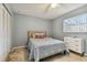 Spacious bedroom with a bed, dresser, and large window at 918 Windward Way, Palm Harbor, FL 34685