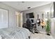 Bright bedroom with a bed, gaming setup, and ample natural light at 918 Windward Way, Palm Harbor, FL 34685