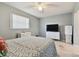 Simple bedroom with a bed, dresser, and TV at 918 Windward Way, Palm Harbor, FL 34685
