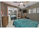 Bedroom with teal bedding, mirrored closet doors, and ceiling fan at 918 Windward Way, Palm Harbor, FL 34685