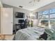 Cozy bedroom with a bed, desk, and window overlooking the backyard at 918 Windward Way, Palm Harbor, FL 34685