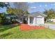 Ranch style home with a white stucco exterior and mature trees at 918 Windward Way, Palm Harbor, FL 34685