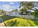 Cute ranch home with white picket fence and well-manicured lawn at 918 Windward Way, Palm Harbor, FL 34685
