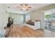 Gathering room with daybed, hardwood floors, and sliding glass doors at 918 Windward Way, Palm Harbor, FL 34685