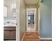 View down hallway showcasing bathroom and bedroom at 918 Windward Way, Palm Harbor, FL 34685