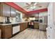 Kitchen with wood cabinets, stainless steel appliances, and vinyl flooring at 918 Windward Way, Palm Harbor, FL 34685