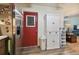 Kitchen area with stainless steel refrigerator and red door at 918 Windward Way, Palm Harbor, FL 34685