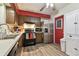Kitchen boasts stainless steel appliances and wood cabinets at 918 Windward Way, Palm Harbor, FL 34685