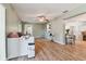 Living room with hardwood floors, daybed, and access to kitchen at 918 Windward Way, Palm Harbor, FL 34685