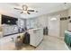 Open living room with a sectional sofa and a large TV at 918 Windward Way, Palm Harbor, FL 34685