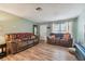 Bright living room with hardwood floors and comfortable brown leather sofas at 918 Windward Way, Palm Harbor, FL 34685