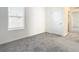 Bedroom with grey carpet and access to hallway and closet at 9231 Forge Breeze Loop, Wesley Chapel, FL 33545