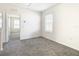 Bedroom with grey carpet and window with blinds at 9231 Forge Breeze Loop, Wesley Chapel, FL 33545