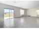 Living room with view of backyard and sliding glass doors leading to patio at 9231 Forge Breeze Loop, Wesley Chapel, FL 33545