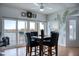 Dining room with water view and leaf wall art at 9359 Blind Pass Rd # 205, St Pete Beach, FL 33706