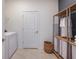 Laundry room with washer, dryer, and storage shelving at 9814 Crescent Moon Dr, Riverview, FL 33578