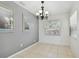 Bright dining room with chandelier and gray accent wall at 1114 20Th Sw St, Largo, FL 33770