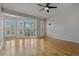 Bright bedroom with hardwood floors, plantation shutters, and a ceiling fan at 115 Brent Cir, Oldsmar, FL 34677