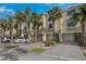 Two-story townhouses with attached garages and palm trees at 115 Brent Cir, Oldsmar, FL 34677