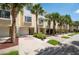 Well-maintained townhomes are surrounded by mature landscaping and palm trees providing great curb appeal at 115 Brent Cir, Oldsmar, FL 34677