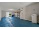 Spacious garage with blue epoxy flooring, shelving, and overhead door at 115 Brent Cir, Oldsmar, FL 34677