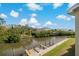 Enjoy the relaxing water view from this condo featuring boat docks and lush landscaping on a sunny day at 115 Brent Cir, Oldsmar, FL 34677