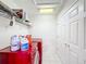 Laundry room with washer, dryer, and storage shelves at 12019 Citrus Leaf Dr, Gibsonton, FL 33534