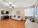 Living room with hardwood floors, neutral colored couches, and ceiling fan at 12019 Citrus Leaf Dr, Gibsonton, FL 33534