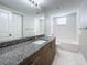 Updated bathroom with granite countertop vanity and white subway tile at 1401 26Th N Ave, St Petersburg, FL 33704