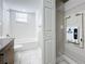 Clean bathroom, bathtub, toilet, and utility closet with shelving at 1401 26Th N Ave, St Petersburg, FL 33704