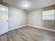 Bright bedroom with wood-look floors and an open door to another room at 1401 26Th N Ave, St Petersburg, FL 33704