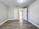 Bedroom with wood-look floors and an open door to the hallway at 1401 26Th N Ave, St Petersburg, FL 33704