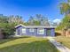 Cute blue house with a landscaped lawn and walkway at 1401 26Th N Ave, St Petersburg, FL 33704