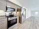 Modern kitchen with stainless steel appliances and wood cabinets at 1401 26Th N Ave, St Petersburg, FL 33704