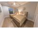 Bedroom with two twin beds, wood floors, and sunburst mirrors at 152 Brightwater Dr # 4, Clearwater Beach, FL 33767