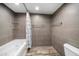 Bathroom with a tub and gray tile at 1591 Gulf Blvd # 504S, Clearwater Beach, FL 33767