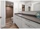 Bathroom with white cabinets and gray tile at 1591 Gulf Blvd # 504S, Clearwater Beach, FL 33767