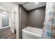 Bathroom with a tub and gray tile at 1591 Gulf Blvd # 504S, Clearwater Beach, FL 33767